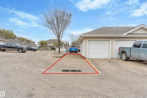 Assigned tandem parking stall providing dedicated vehicle accommodation - 73 3040 Spence Wynd, Edmonton, AB - Outdoor
