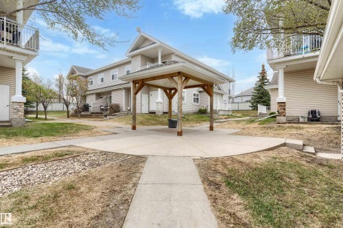 Central patio area featuring a wooden gazebo structure over a concrete pad - 73 3040 Spence Wynd, Edmonton, AB - Outdoor