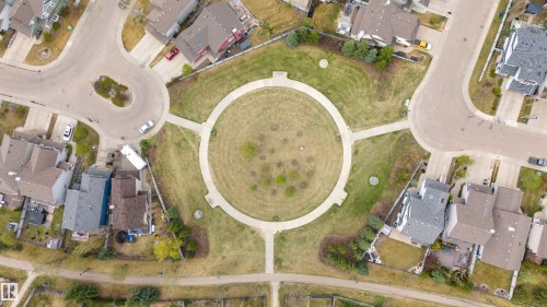 Circular park space with walking paths, surrounded by residential properties and paved streets - 73 3040 Spence Wynd, Edmonton, AB - Other