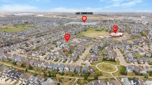 Aerial perspective of a developed residential neighborhood featuring numerous single-family homes and a central green space - 73 3040 Spence Wynd, Edmonton, AB - Outdoor With View