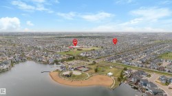 Aerial perspective showcasing a residential community with a large central lake - 