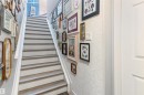 Staircase featuring wood-finish treads, white risers, and a white handrail - 73 3040 Spence Wynd, Edmonton, AB  - Indoor Photo Showing Other Room 