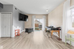 Spacious room featuring light wood-finish flooring and a neutral color palette - 
