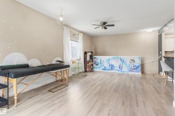 Spacious room featuring light wood-finish flooring, neutral wall tones, and recessed lighting - 