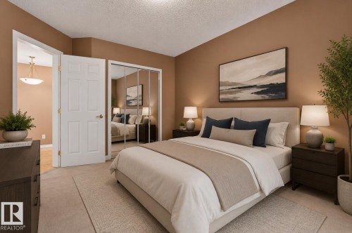Carpeted bedroom featuring a built-in closet with mirrored sliding doors, recessed ceiling lighting, and a white six-panel door - 104 9760 174 Street, Edmonton, AB - Indoor Photo Showing Bedroom
