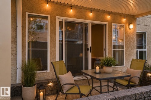 Covered patio with textured stucco exterior - 104 9760 174 Street, Edmonton, AB - Outdoor With Deck Patio Veranda With Exterior