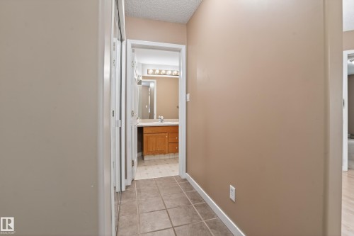 Hallway with neutral wall paint and white trim - 104 9760 174 Street, Edmonton, AB - Indoor Photo Showing Other Room