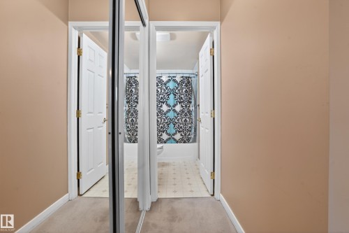 Hallway with neutral tone walls and carpet flooring - 104 9760 174 Street, Edmonton, AB - Indoor Photo Showing Other Room