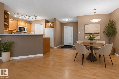 Open-concept living space featuring wood-finish flooring - 104 9760 174 Street, Edmonton, AB - Indoor Photo Showing Dining Room