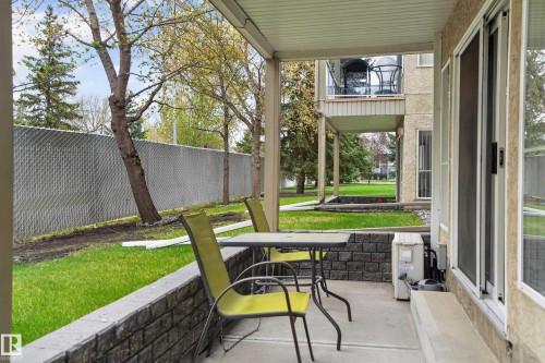 Ground-level concrete patio with a decorative retaining wall - 104 9760 174 Street, Edmonton, AB - Outdoor With Deck Patio Veranda With Exterior