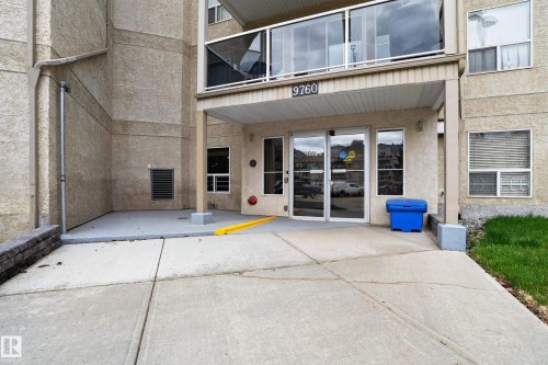 Building exterior featuring stucco finish and a covered entrance - 104 9760 174 Street, Edmonton, AB - Outdoor