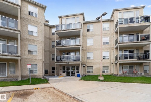 Multi-story stucco building featuring multiple private balconies with glass railings - 104 9760 174 Street, Edmonton, AB - Outdoor With Facade