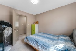 Inviting room with light-colored walls and carpeted flooring - 