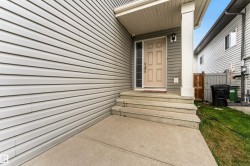Welcoming front entrance with concrete steps and a covered porch - 