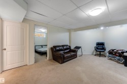 Carpeted room featuring a drop ceiling with recessed lighting and a flush mount ceiling light - 