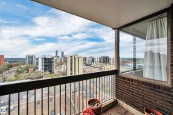 Balcony featuring a metal railing and a partial brick wall - 