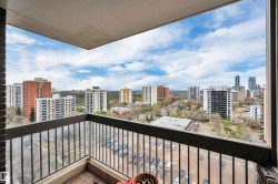 Private balcony with metal railings and a city skyline backdrop - 