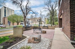 Brick exterior building with an adjacent red paver patio - 