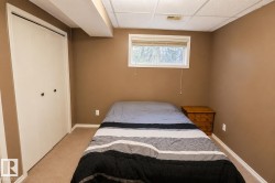 Carpeted room with a window, white trim, and a bi-fold closet - 