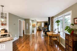 Expansive open-concept interior featuring wood-finish flooring throughout - 