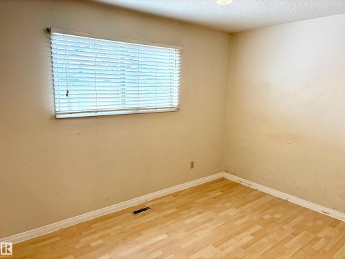 Room featuring light-colored walls, light wood-look flooring, and a window with blinds - 15208 92 Street, Edmonton, AB - Indoor Photo Showing Other Room