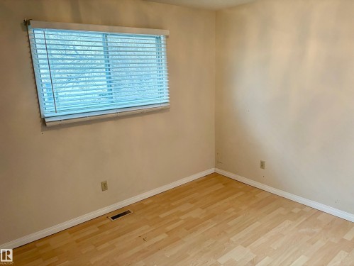 This room features light-colored walls and light-toned flooring - 15208 92 Street, Edmonton, AB - Indoor Photo Showing Other Room