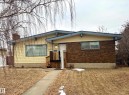 The property features a brick and siding exterior, a wooden deck, and a concrete pathway leading to the entrance - 15208 92 Street, Edmonton, AB  - Outdoor 