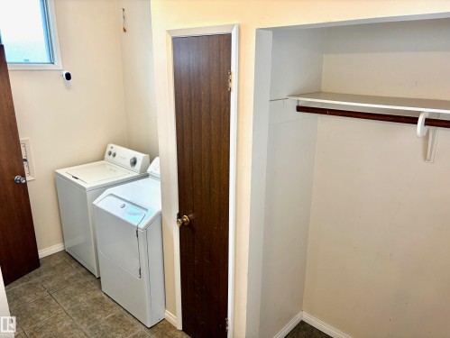 The property features a dedicated laundry area with a washing machine and dryer, tiled flooring, and a window - 15208 92 Street, Edmonton, AB - Indoor Photo Showing Laundry Room