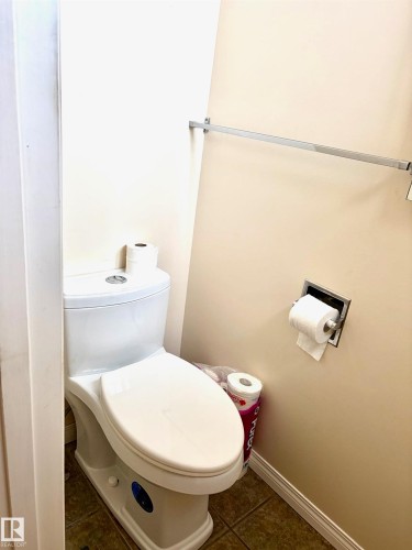 The property features a private water closet with a white toilet and an integrated wall-mounted toilet paper holder - 15208 92 Street, Edmonton, AB - Indoor Photo Showing Bathroom