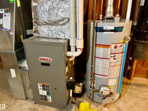 The property includes a Lennox furnace and a ProLine hot water heater - 15208 92 Street, Edmonton, AB - Indoor Photo Showing Basement