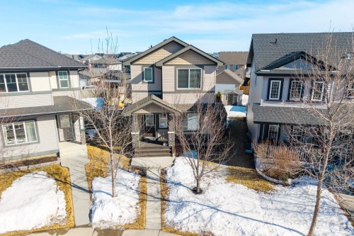 Two-story residence featuring light gray siding and dark trim accents - 7074 Cardinal Way, Edmonton, AB - Outdoor With Facade
