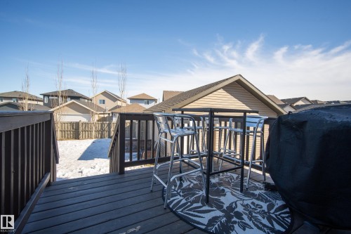 Expansive wood deck with dark-stained railing - 7074 Cardinal Way, Edmonton, AB - Outdoor