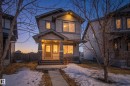 Two-story residence featuring light gray siding, dark trim, and stone accents on the front facade - 7074 Cardinal Way, Edmonton, AB  - Outdoor 