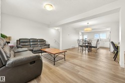 Open-concept living space featuring light wood-finish flooring throughout - 