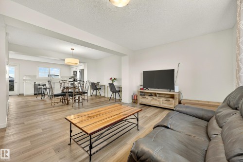 Open-concept living space featuring wood-finish flooring, white walls, and recessed lighting - 38 Jensen Gate, St. Albert, AB - Indoor Photo Showing Living Room