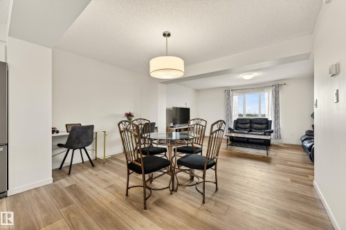 Open-concept living area with wood-finish flooring throughout - 38 Jensen Gate, St. Albert, AB - Indoor Photo Showing Dining Room