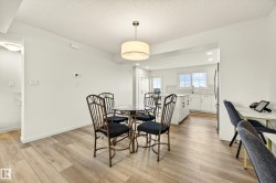Open-concept dining area with wood-finish flooring - 