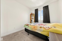 Bright room featuring a window with natural light, neutral wall paint, and gray carpet flooring - 