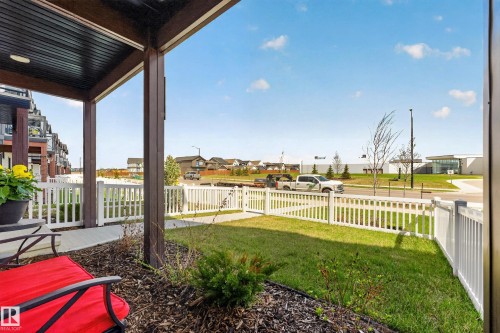 Covered front porch with dark wood-finish columns and ceiling - 38 Jensen Gate, St. Albert, AB - Outdoor