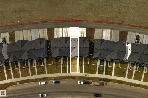 Aerial view showcasing a residential street with multiple properties, each featuring a dark-toned roof and light-toned front yard paths - 38 Jensen Gate, St. Albert, AB - Indoor Photo Showing Bathroom