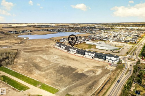 Aerial perspective showcasing a row of contemporary townhomes - 38 Jensen Gate, St. Albert, AB - Outdoor With View