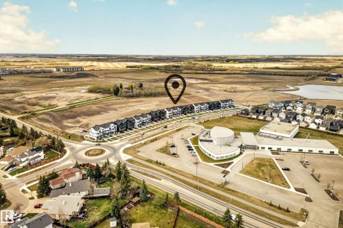 Aerial perspective showcasing a developing residential area with a series of modern townhomes - 38 Jensen Gate, St. Albert, AB - Outdoor With View