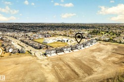 Aerial perspective showcasing a developing residential area with townhomes and detached properties - 