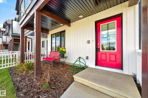 Entryway with a vibrant red door featuring a full-light window and lower panel detailing - 38 Jensen Gate, St. Albert, AB - Outdoor