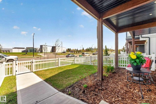 Covered porch with wood-finish structural beams and a black corrugated ceiling - 38 Jensen Gate, St. Albert, AB - Outdoor