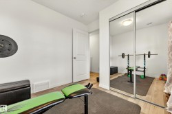 Room featuring light wood-finish flooring and a white paneled interior door - 