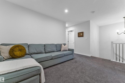 Carpeted recreation room featuring recessed lighting and a white interior door - 17319 2 St Nw, Edmonton, AB - Indoor Photo Showing Living Room