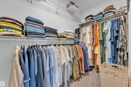 Well-appointed closet featuring white wire shelving and hanging rods - 17319 2 St Nw, Edmonton, AB - Indoor With Storage