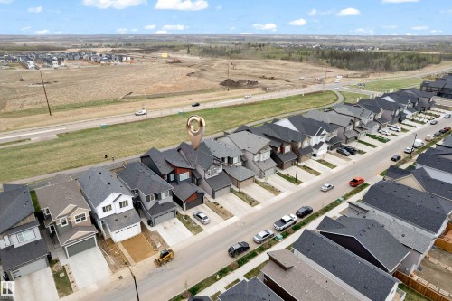Modern residential development featuring a street of multi-story homes with attached garages - 17319 2 St Nw, Edmonton, AB - Outdoor With View