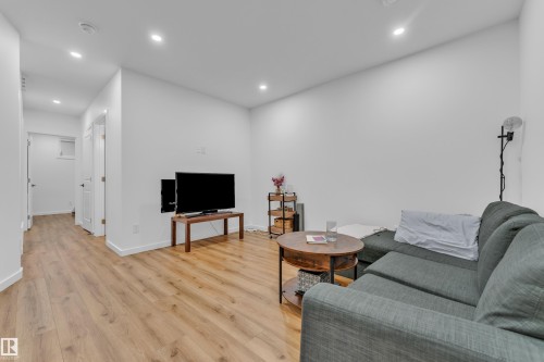 Living area featuring wood-finish flooring, white painted walls, and recessed lighting - 17319 2 St Nw, Edmonton, AB - Indoor